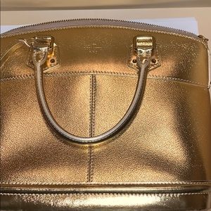 Louis Vuitton gold bag.